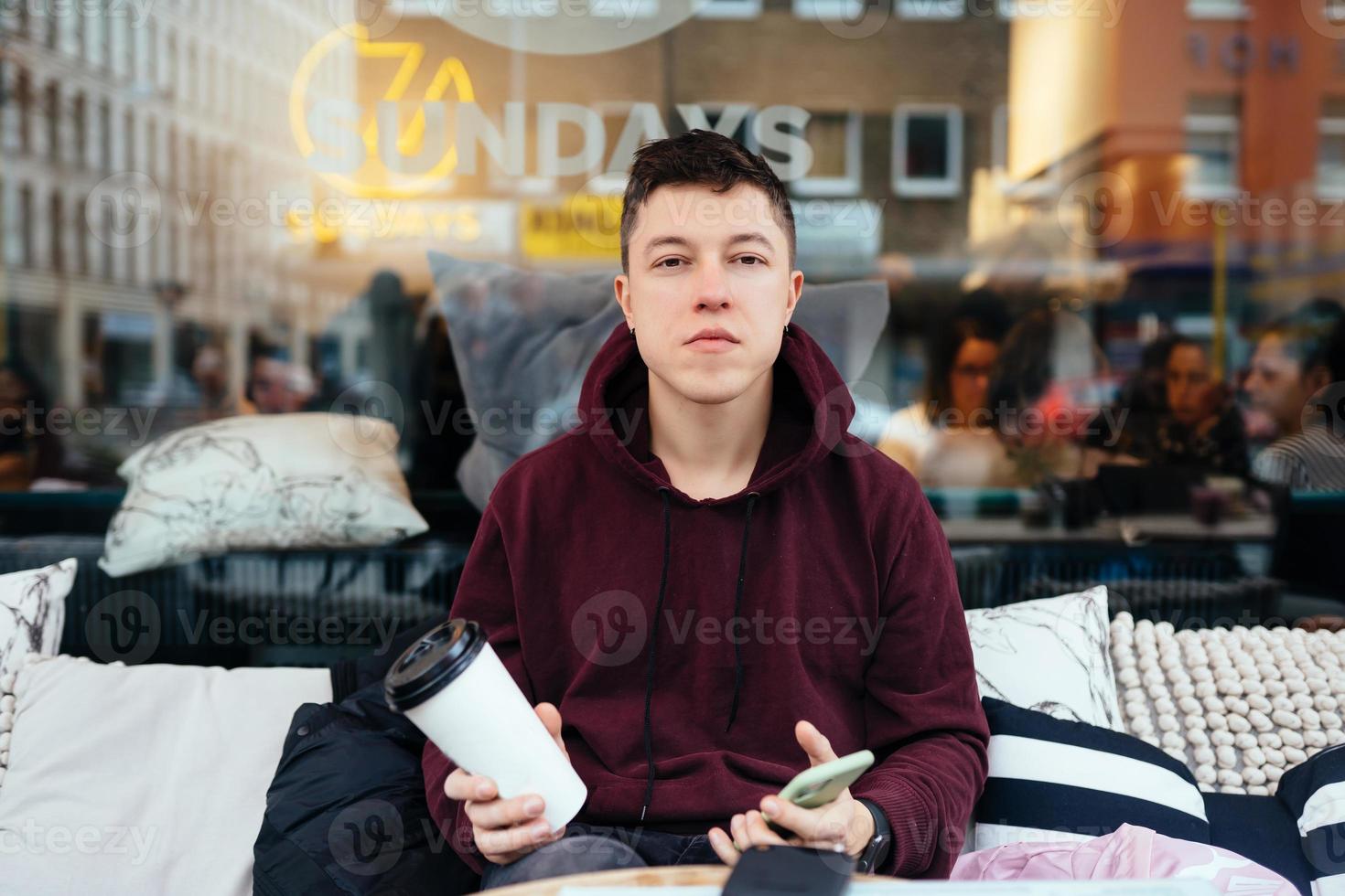 Handsome guy hanging out in an outdoor cafe photo