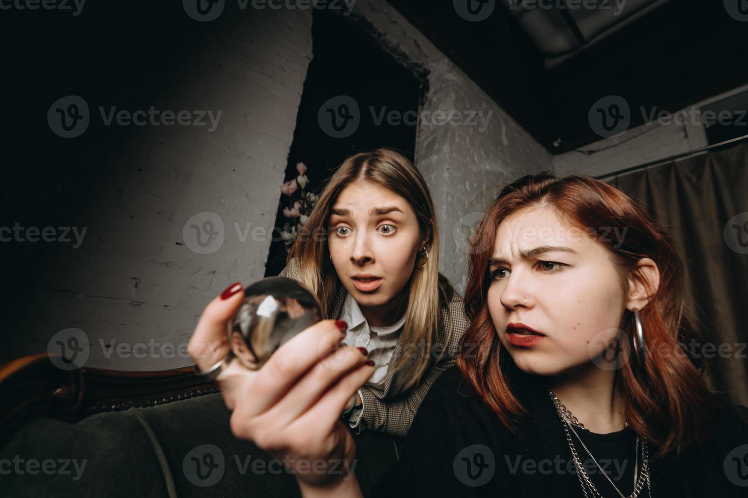 Woman and woman fortune teller with crystal ball photo