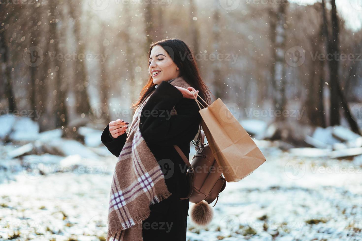 Young beautiful model posing in winter forest. stylish fashion portrait photo