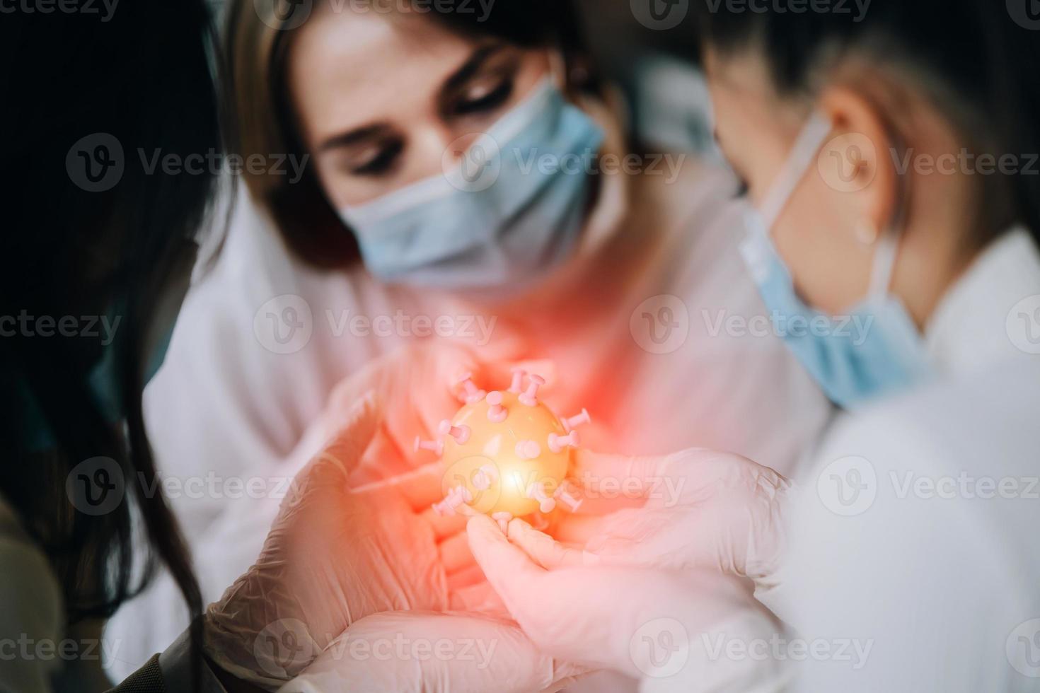 Scientist virologist holding model of new Coronavirus or COVID-19 photo