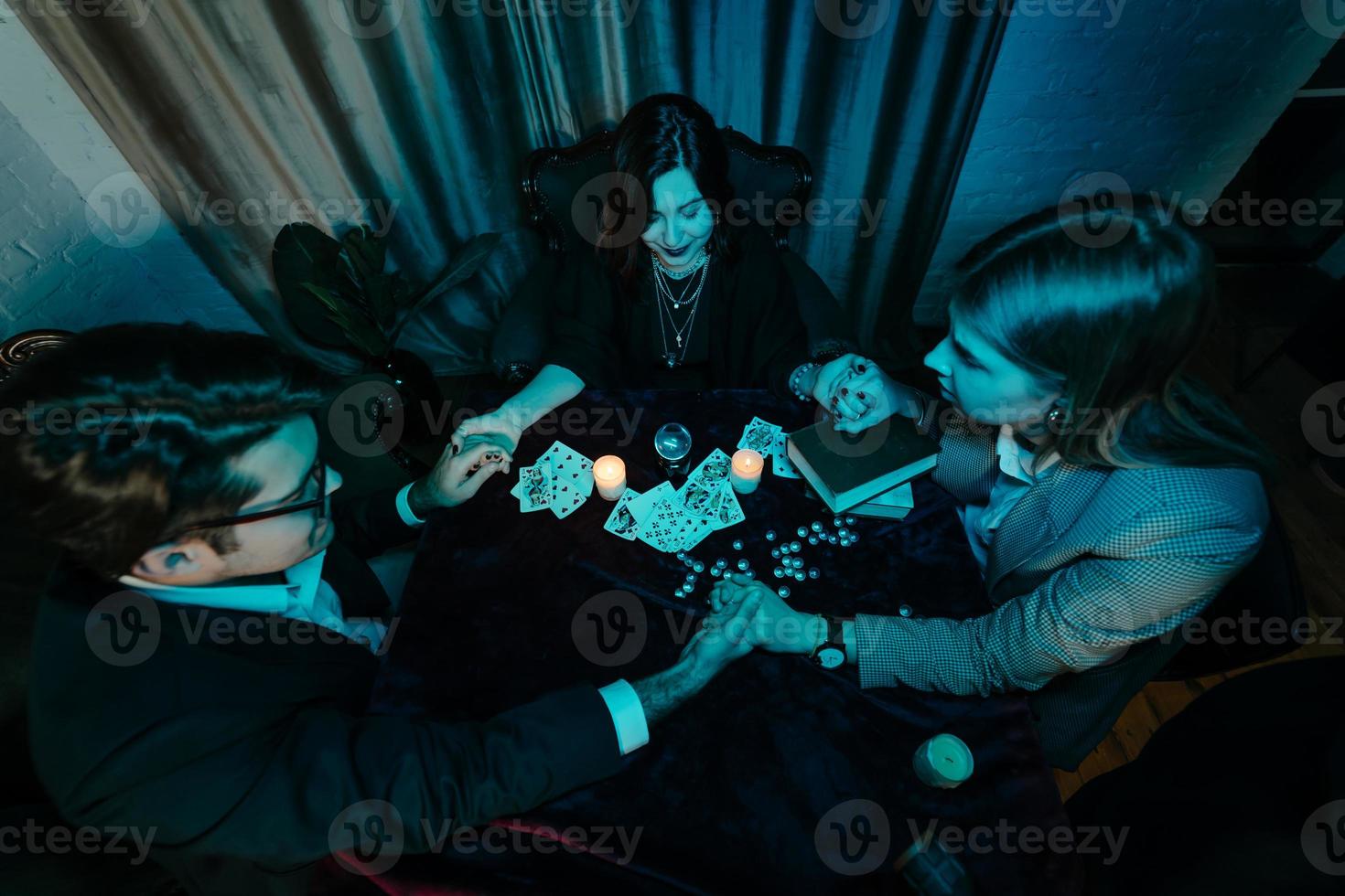 People hold hands of night at table with candles photo