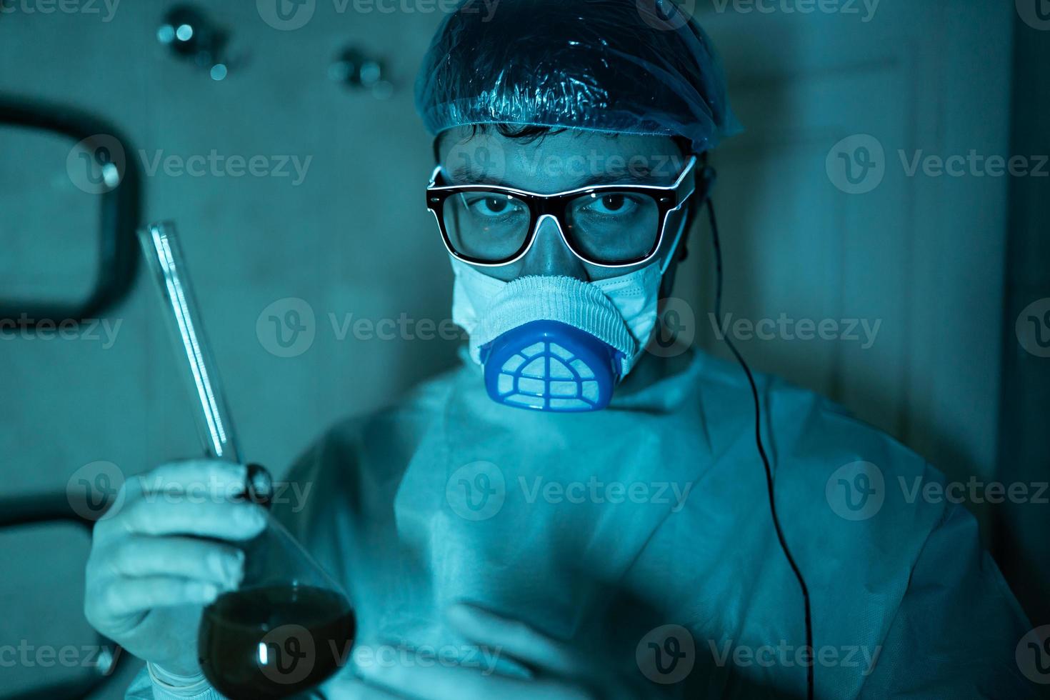 Young male researcher carrying out scientific experiment. photo