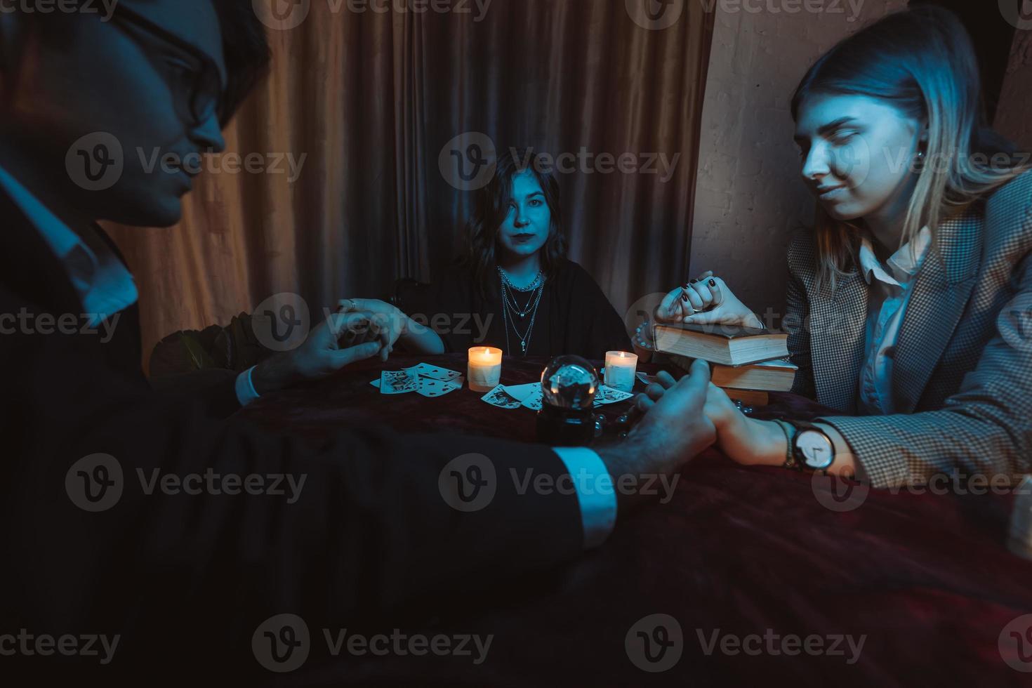 People hold hands of night at table with candles photo