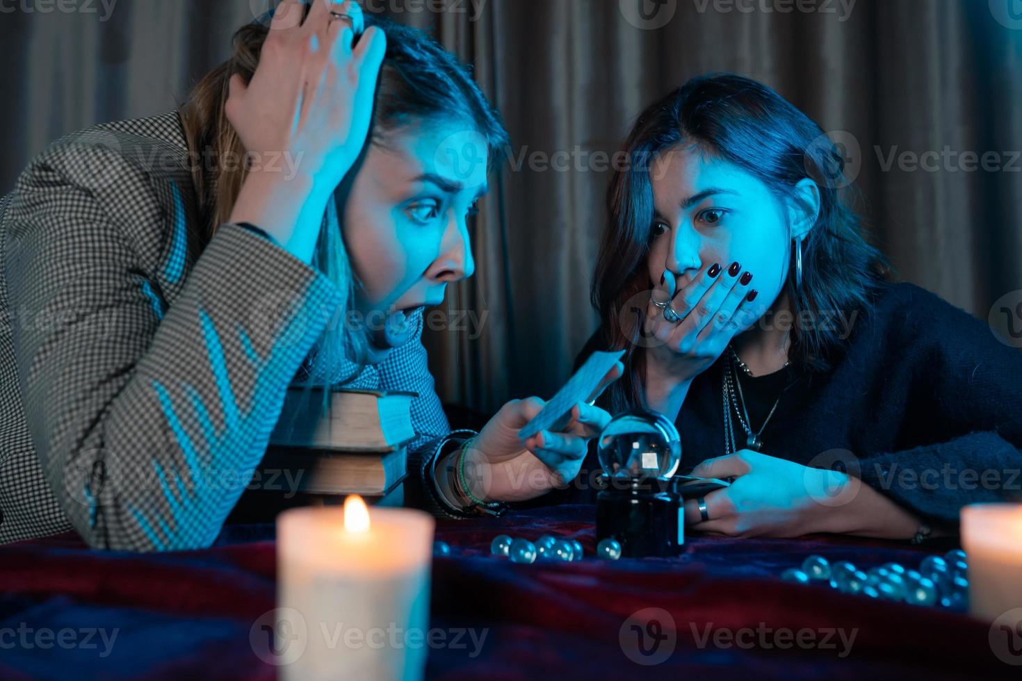 Woman and woman fortune teller with crystal ball photo