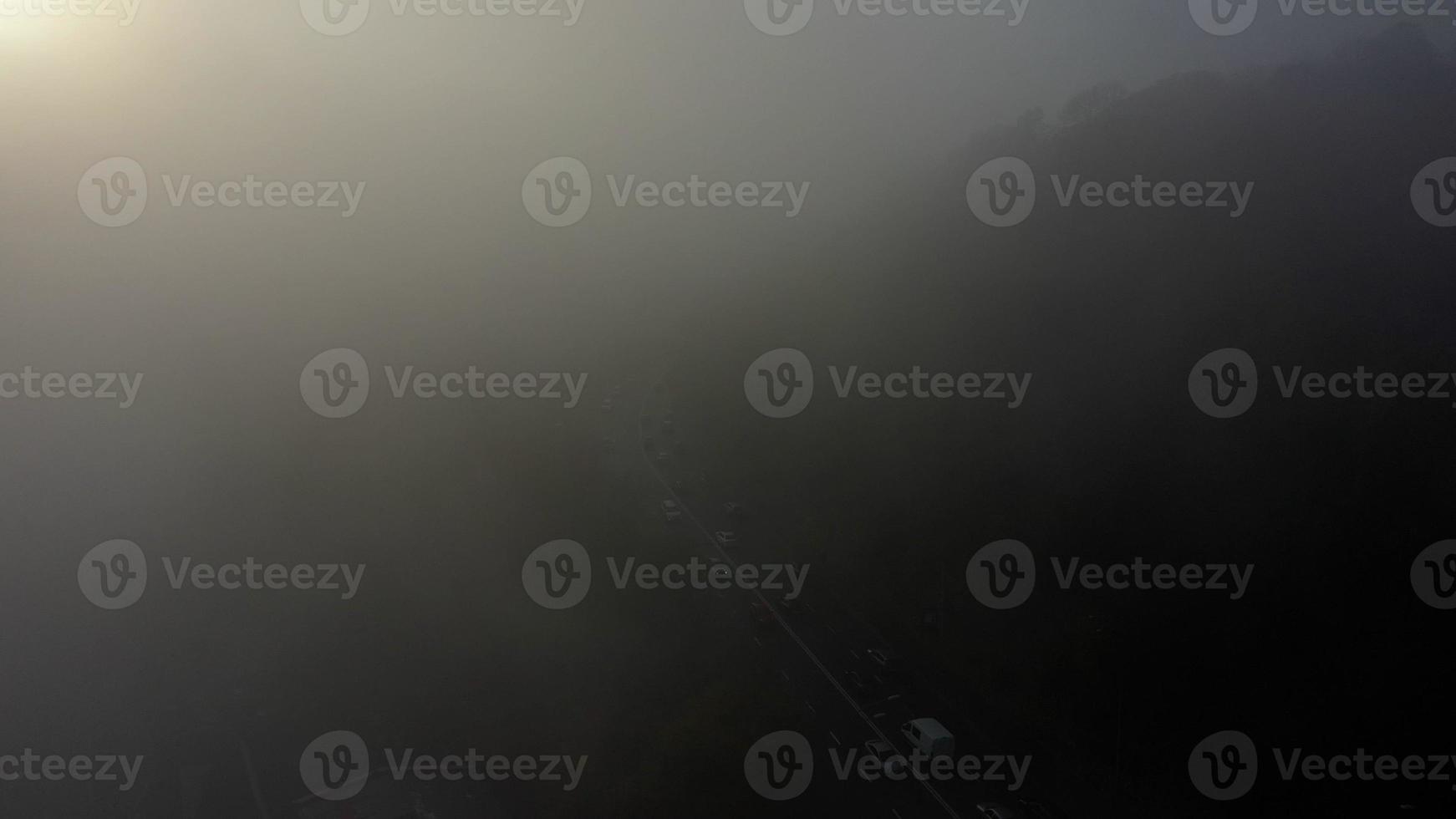 A city covered in fog. City traffic, aerial view photo