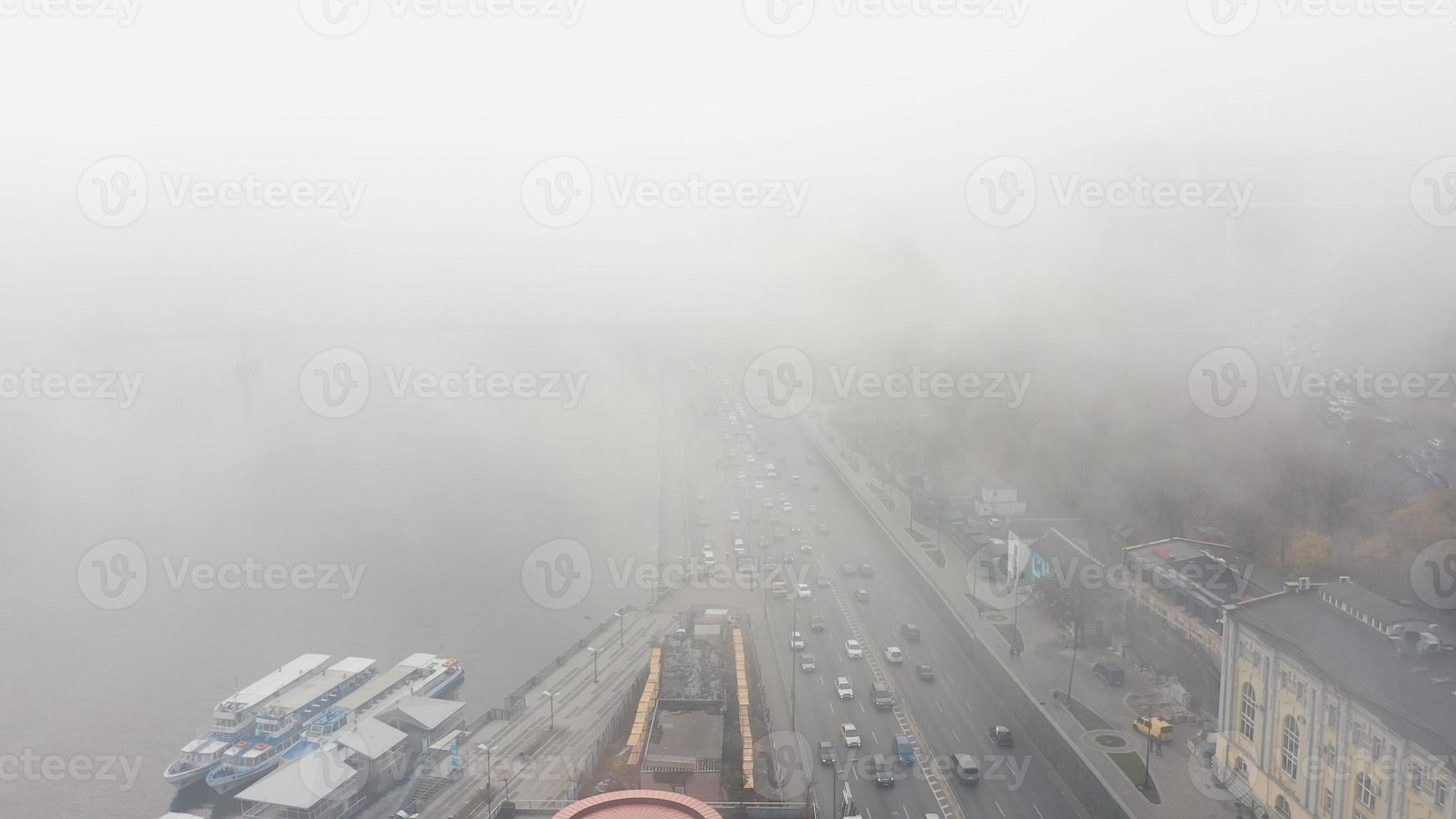 A city covered in fog. City traffic, aerial view photo
