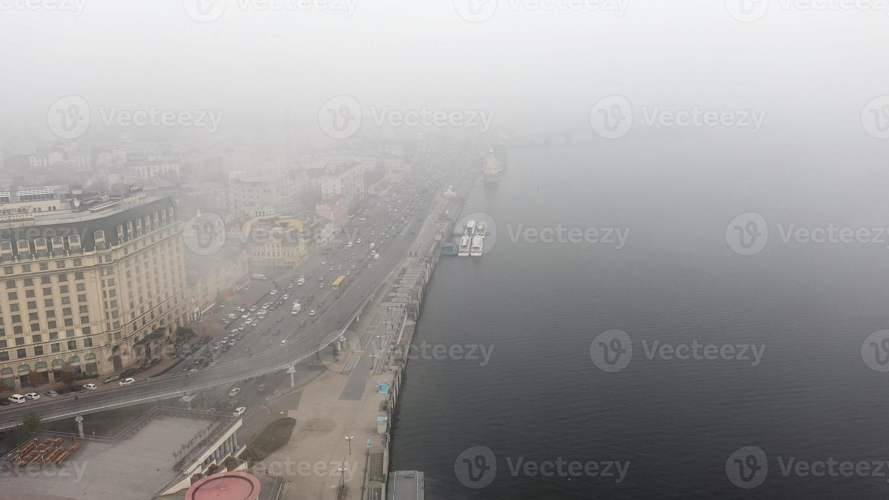 A city covered in fog. City traffic, aerial view photo