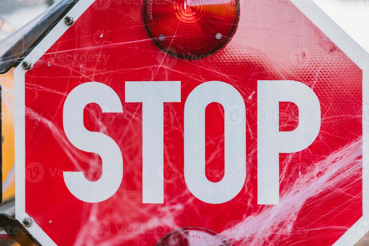 School bus with stop sign decorated with cobwebs photo