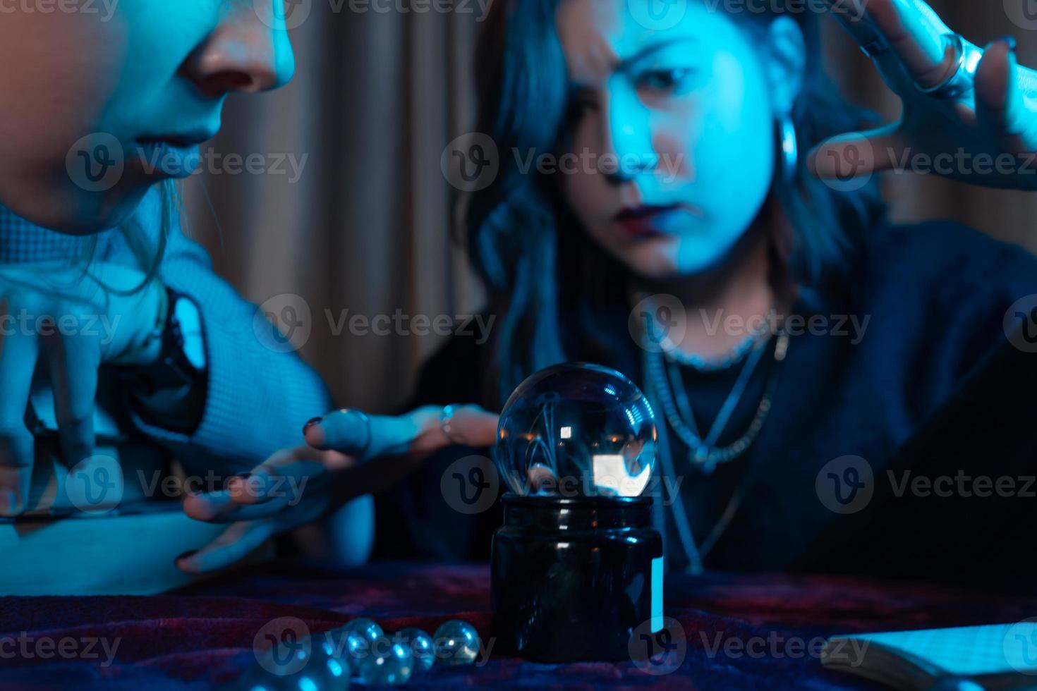 Woman and woman fortune teller with crystal ball photo