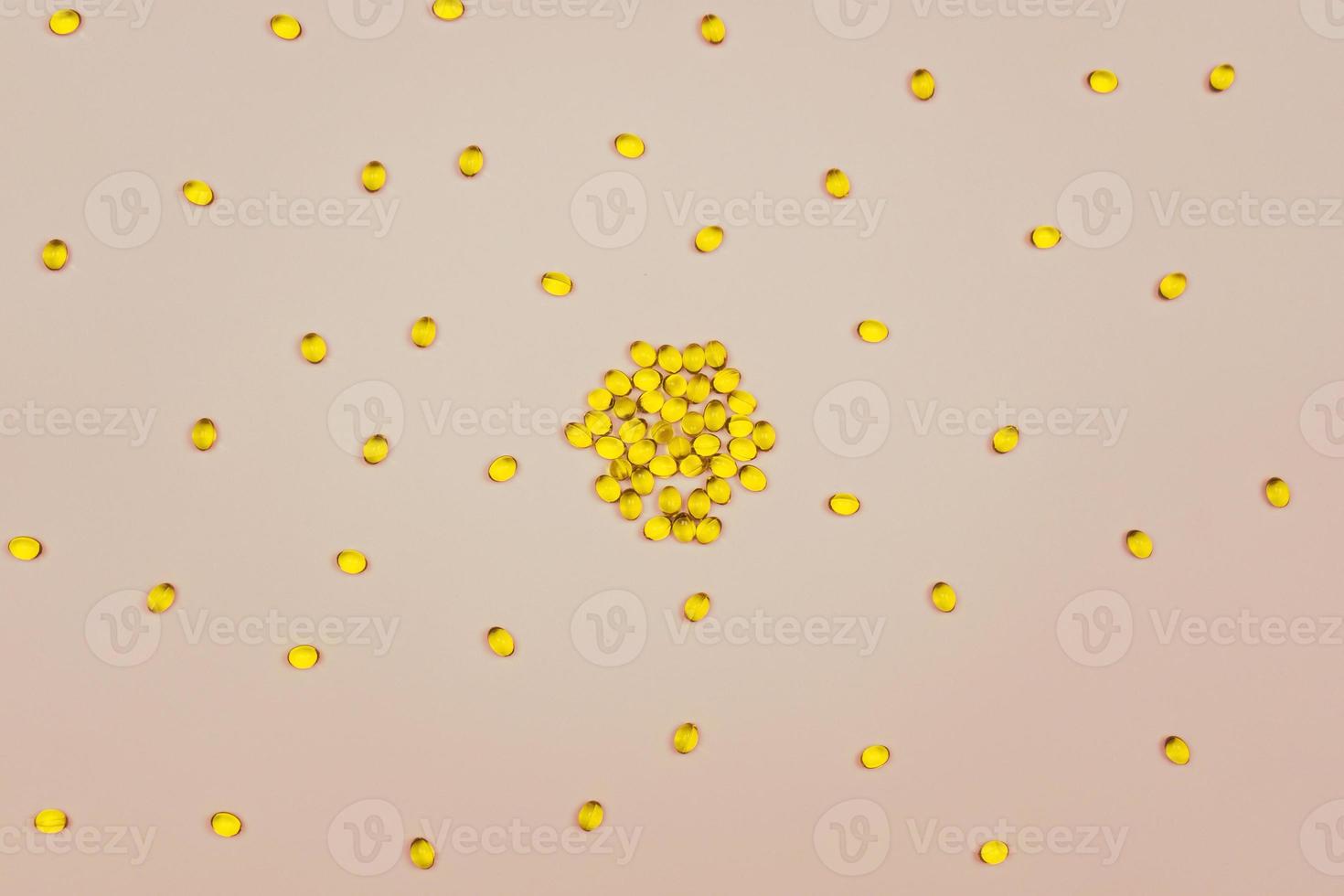 Small capsules of Omega 3 lying on a blue background photo