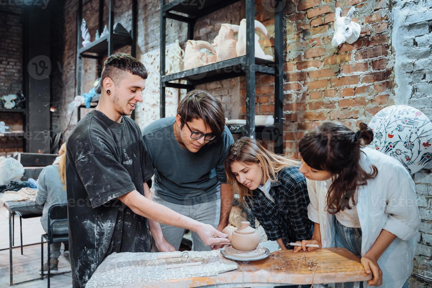 Making a handmade clay pot in the workshop. Pottery lesson with master. photo