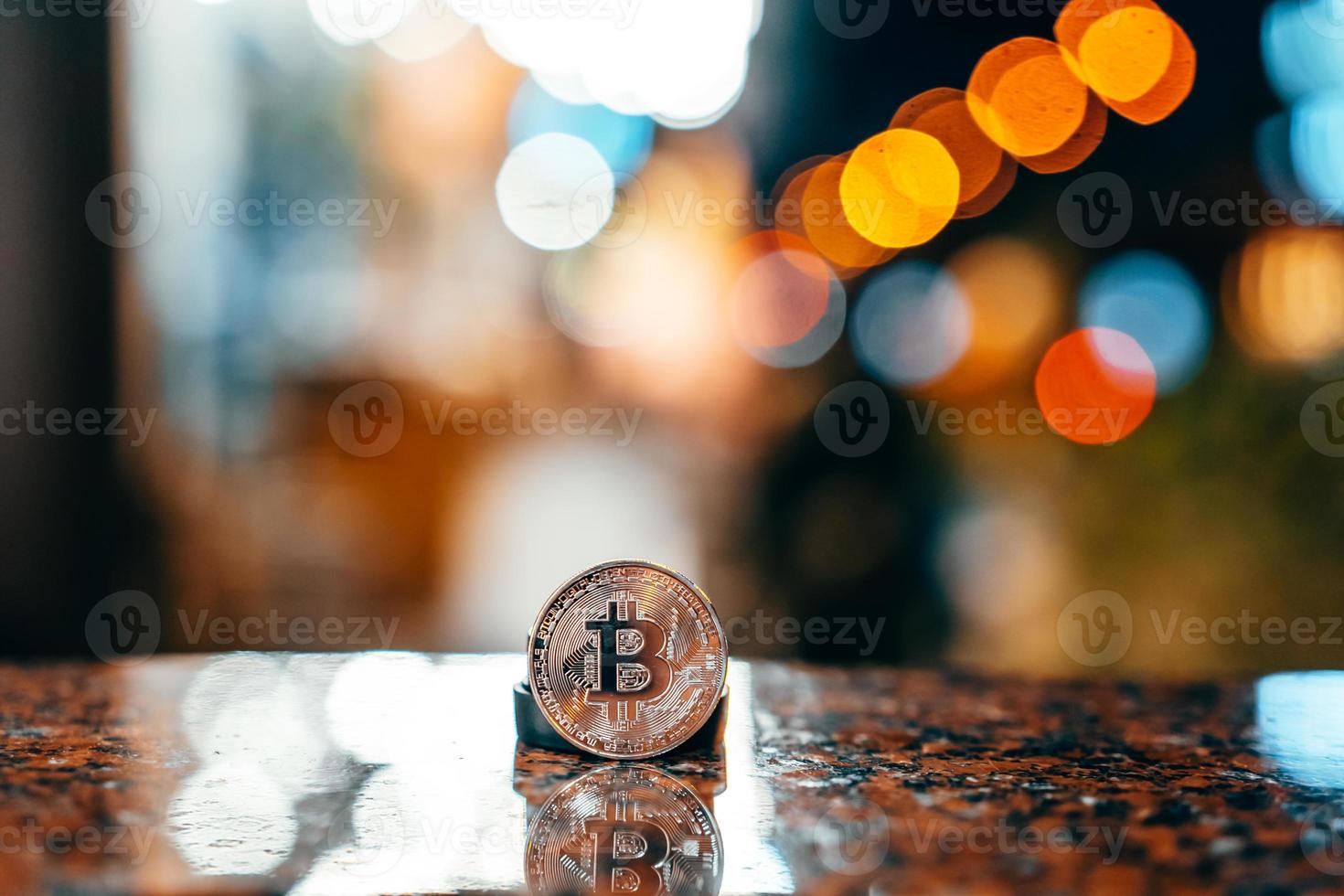 Silver bitcoin isolated on the table, glowing background photo