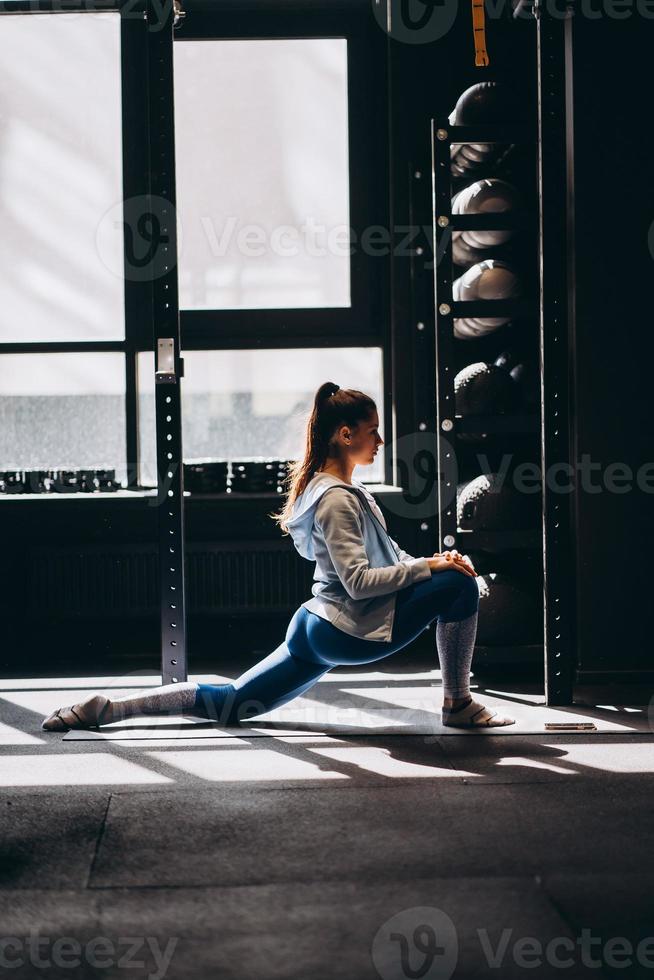 Portrait of attractive young woman doing yoga or pilates exercise photo