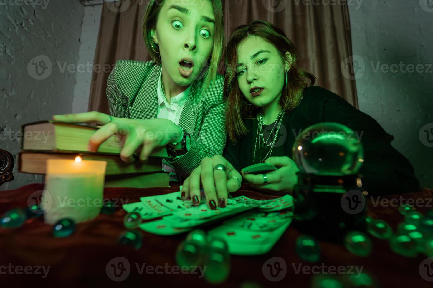 Fortune teller forecasting the future to woman with cards photo