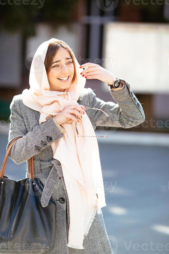 girl in a coat on the street photo