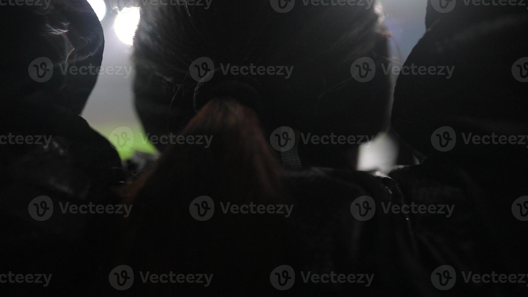 People go in for sports at night stadium in rainy weather photo