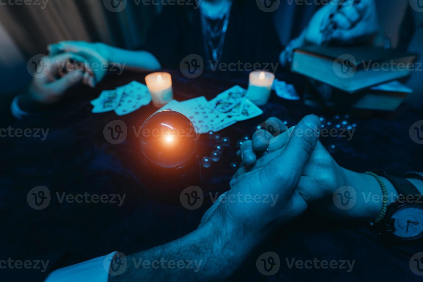 la gente se da la mano de la noche en la mesa con velas foto