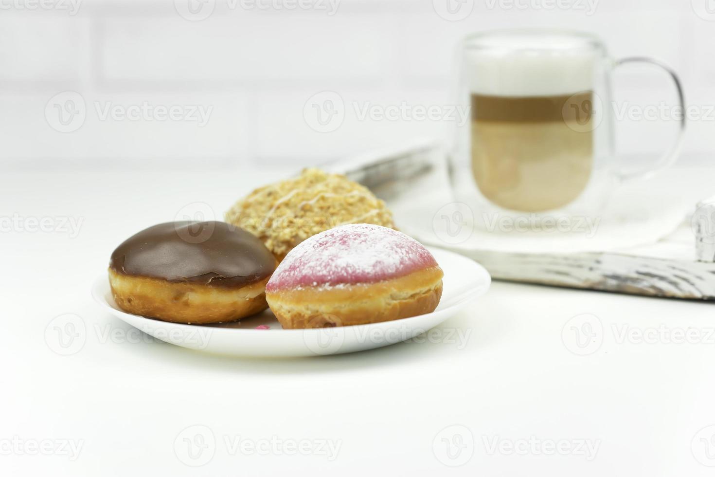 A cup of latte stands on a wooden tray for early breakfast photo