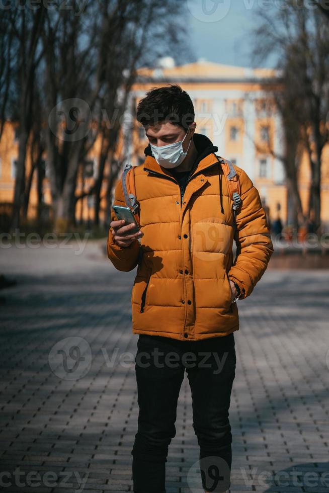 Guy in a park with a cotton mask as an extra protection photo