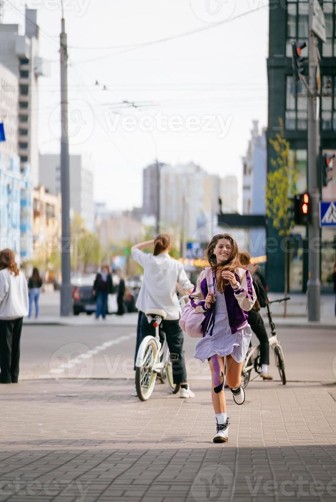 Pretty young woman, walking at the street. photo