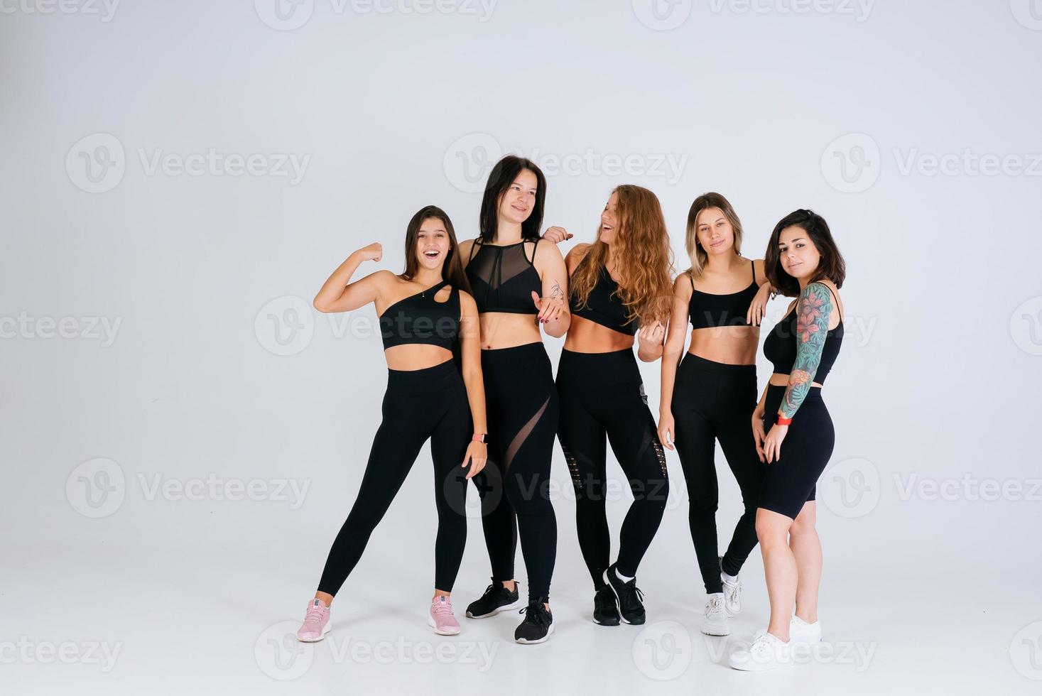 diverse models laughing, enjoying time together, look at camera photo