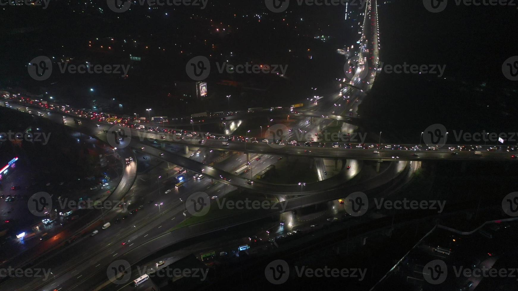 Aerial view of highway interchange at night, timelapse. photo