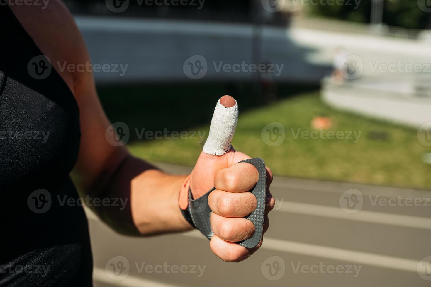 cropped view of sexy bodybuilder showing thumbs up photo