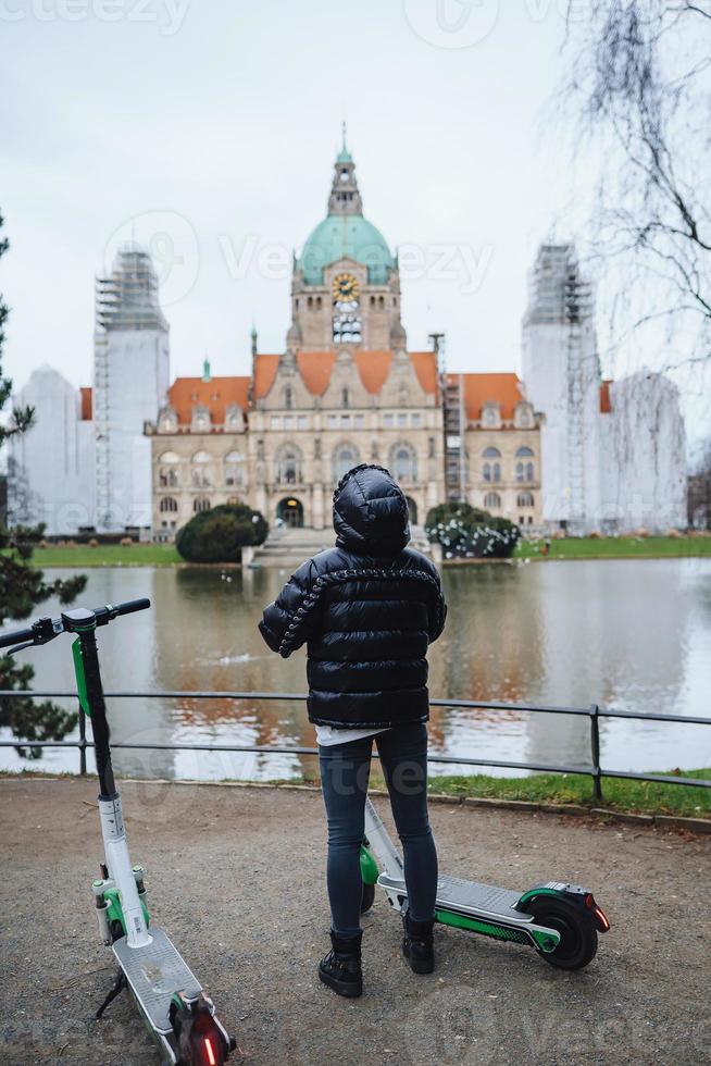 Young girl in Mash Park against the background of the New Town Hall photo