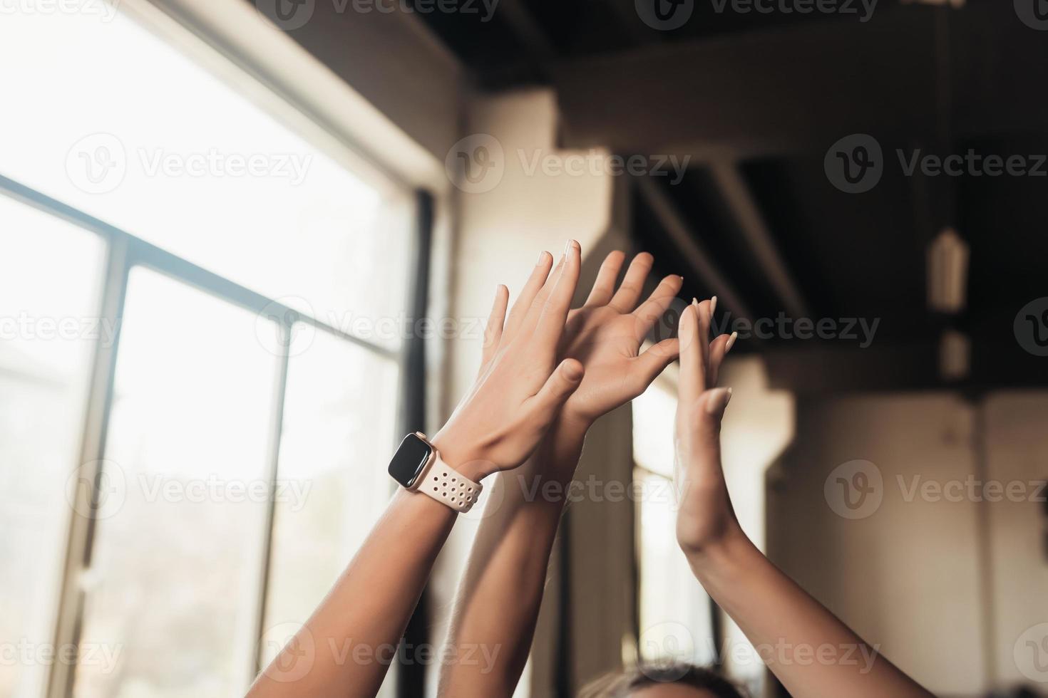 Women giving five each other after having a great workout in gym. photo