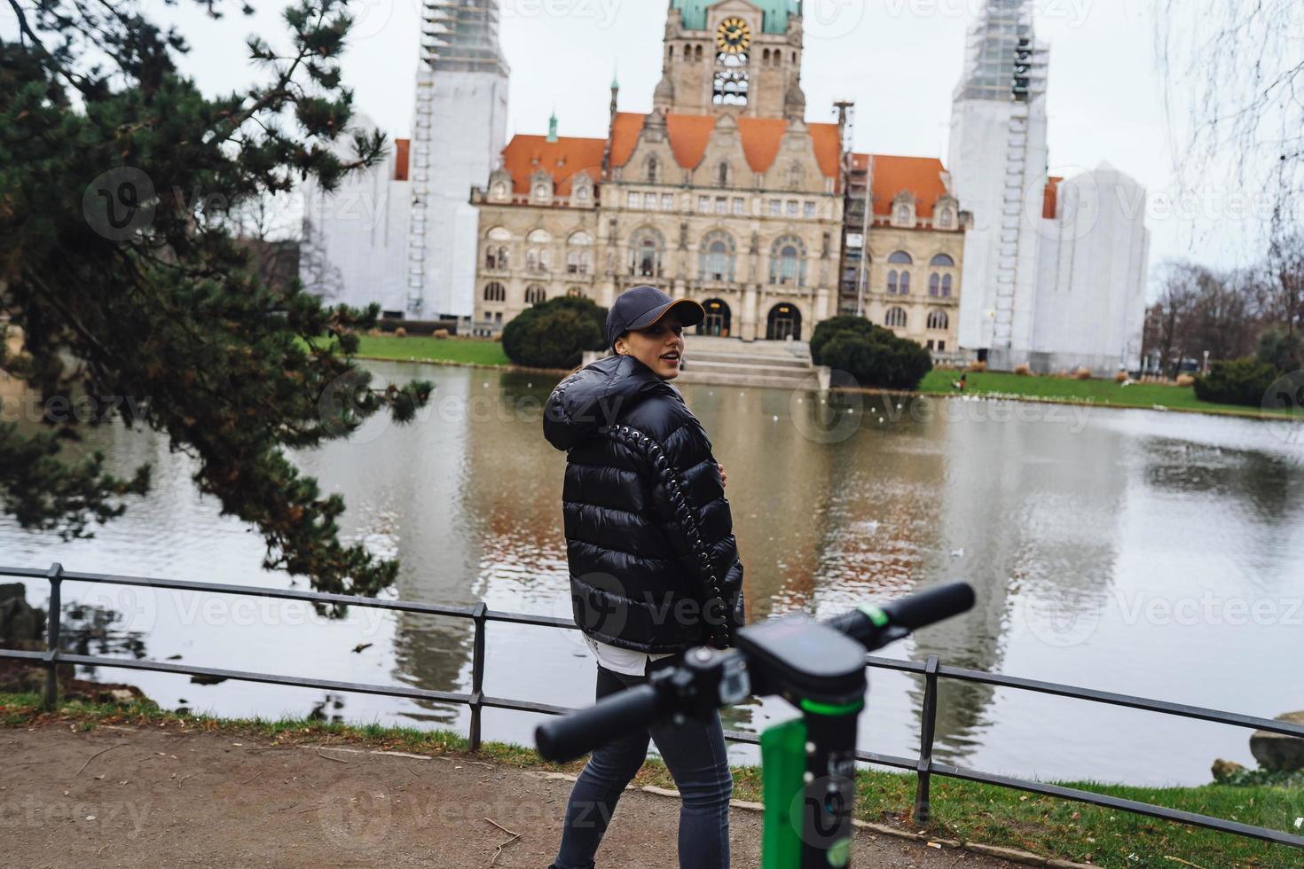 Young girl in Mash Park against the background of the New Town Hall photo