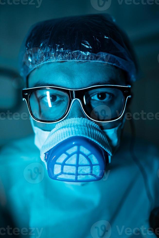 Young male researcher carrying out scientific experiment. photo