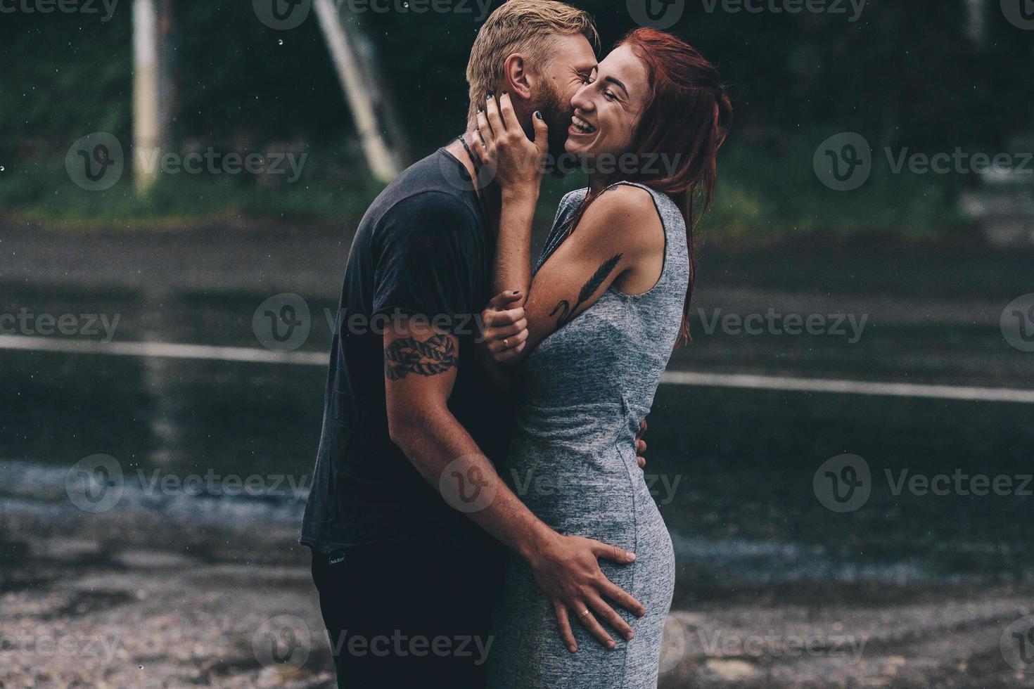 beautiful couple hugging in the rain photo