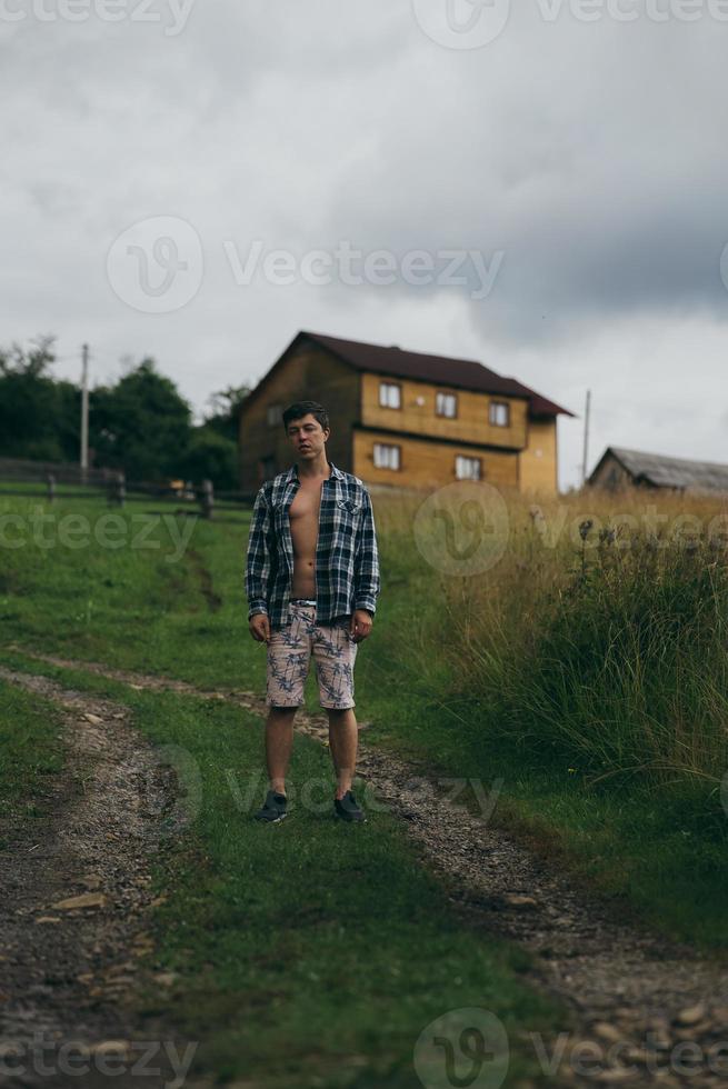 The guy in a shirt and shorts on the side of the hill photo