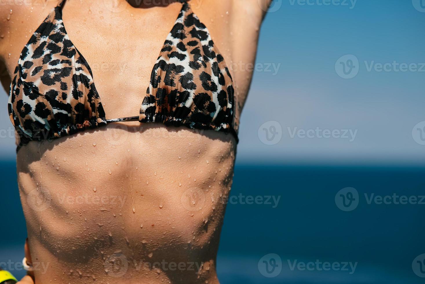 Torso of slim attractive female with flat belly in white underwear. photo