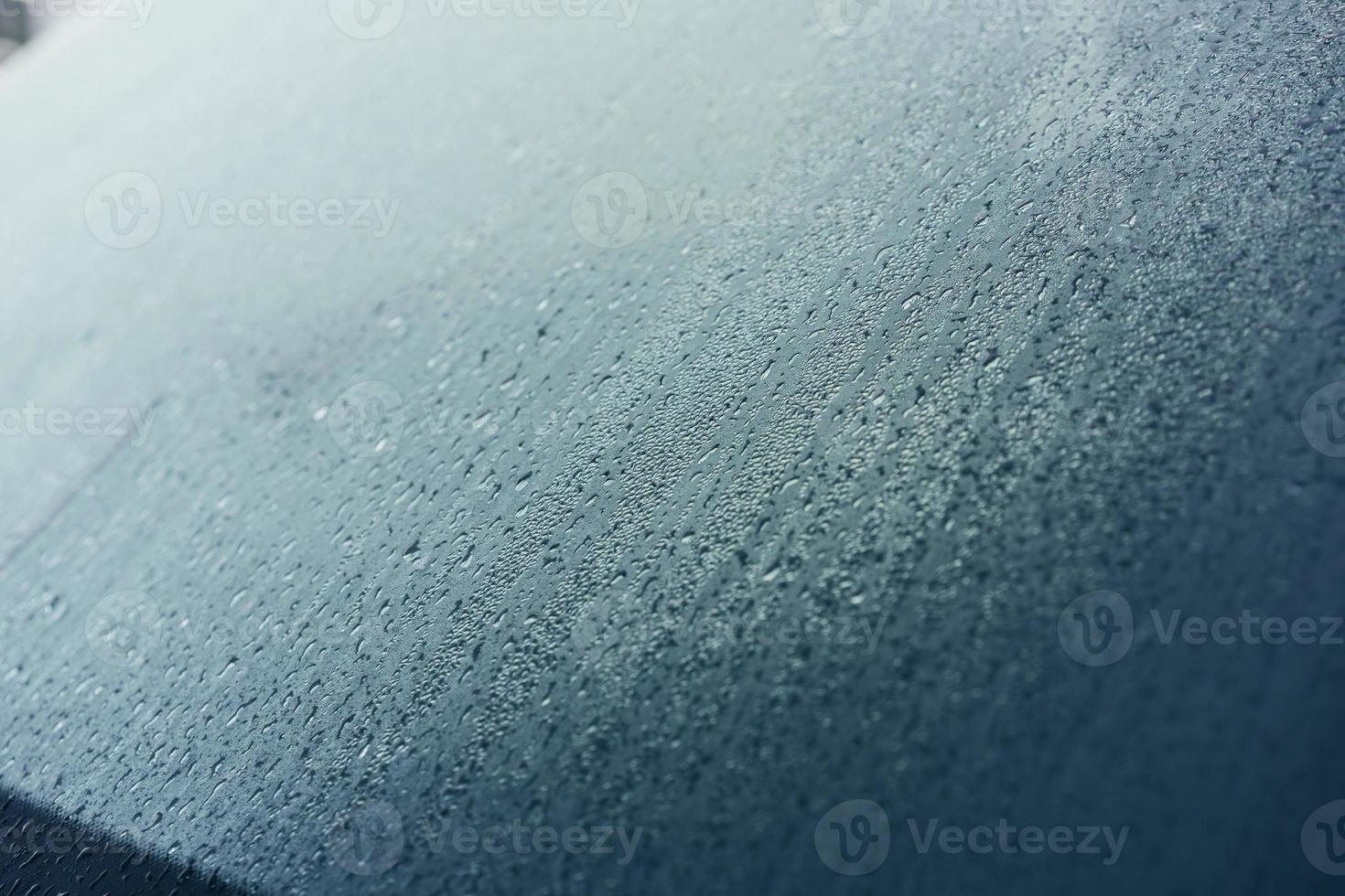 Raindrops on the hood of the car. Close-up. photo