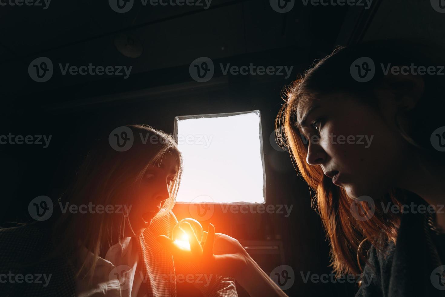 Woman and woman fortune teller with crystal ball photo