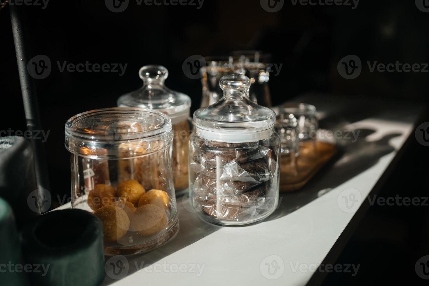 Four glass cups on the bar counter with serving accessories. photo