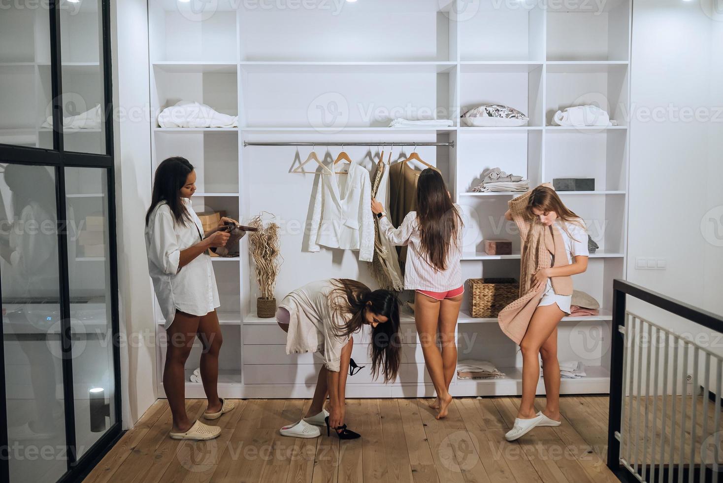 Beautiful girls choose their clothes at home photo