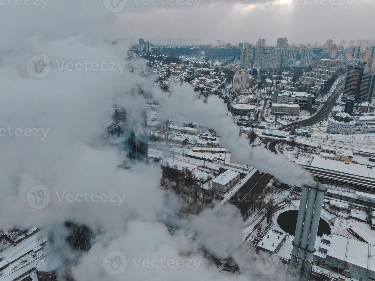 Large central boiler room with giant pipes of which there is dangerous smoke in winter during frost in a big city photo