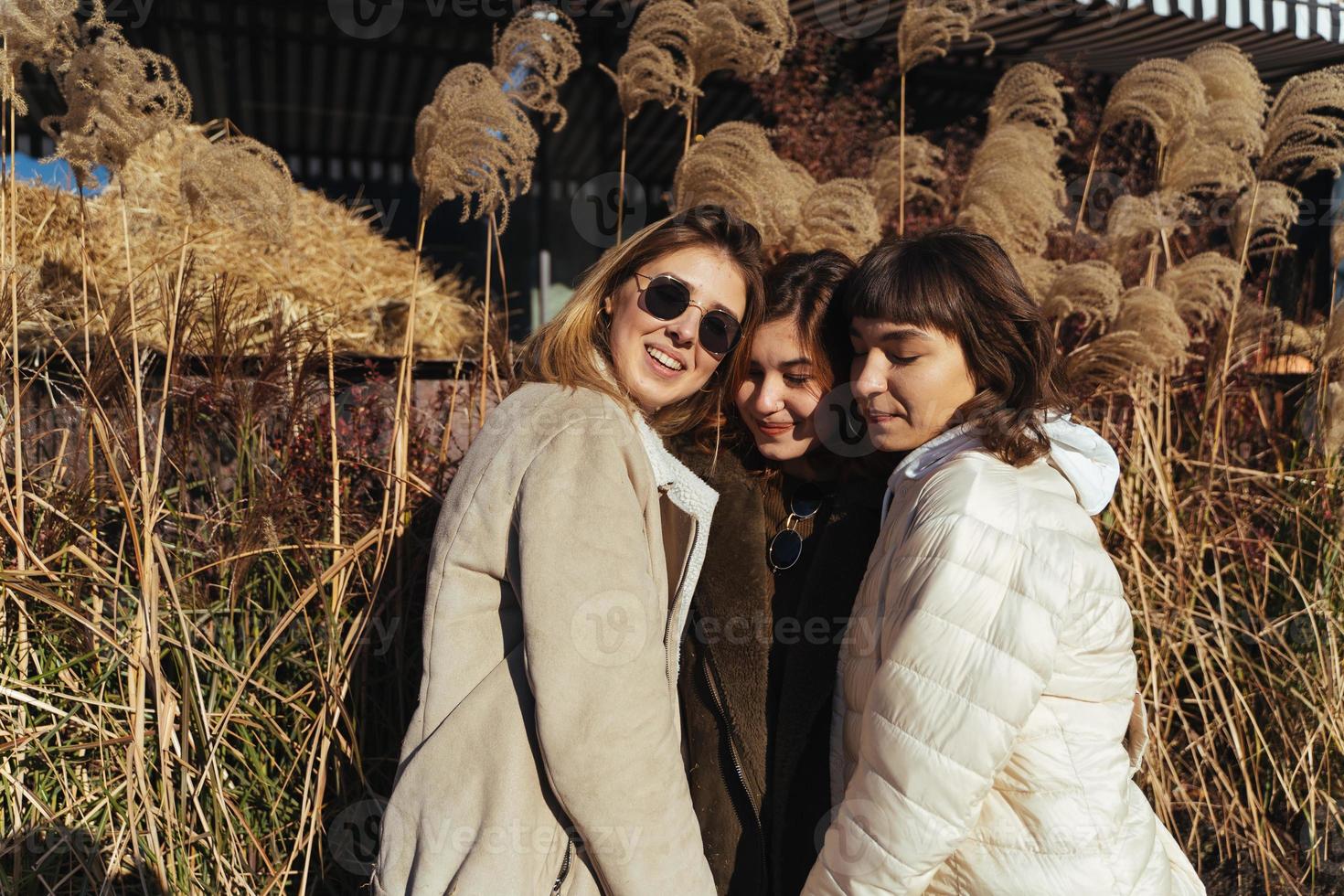 Carefree women posing on the street background. photo