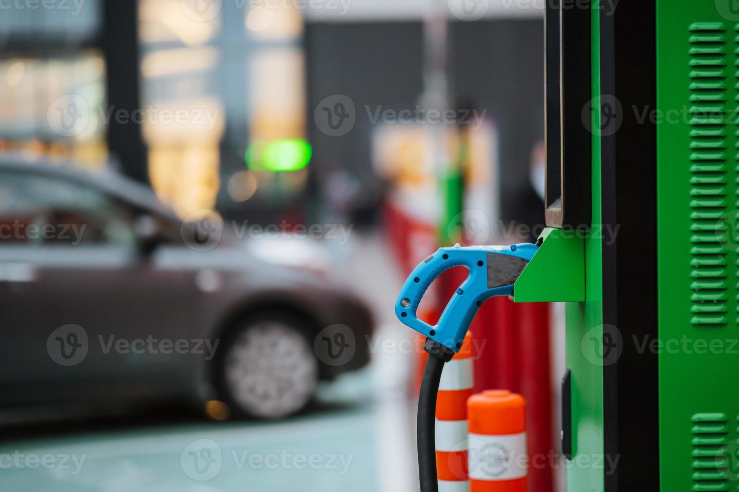 Close up power cord for electric car. Green station photo