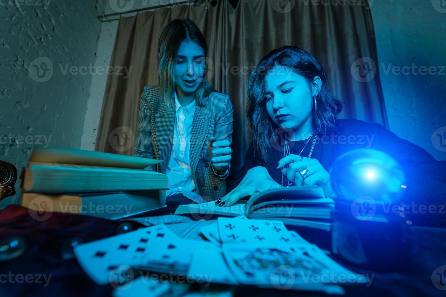 Two women are reading a mysterious book photo