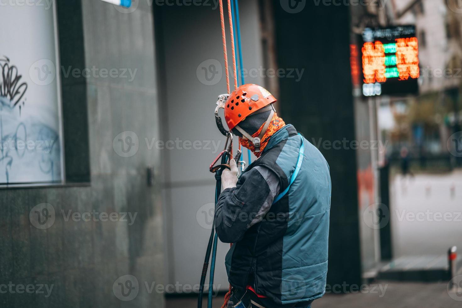 Worker climber preparing for work at height. photo