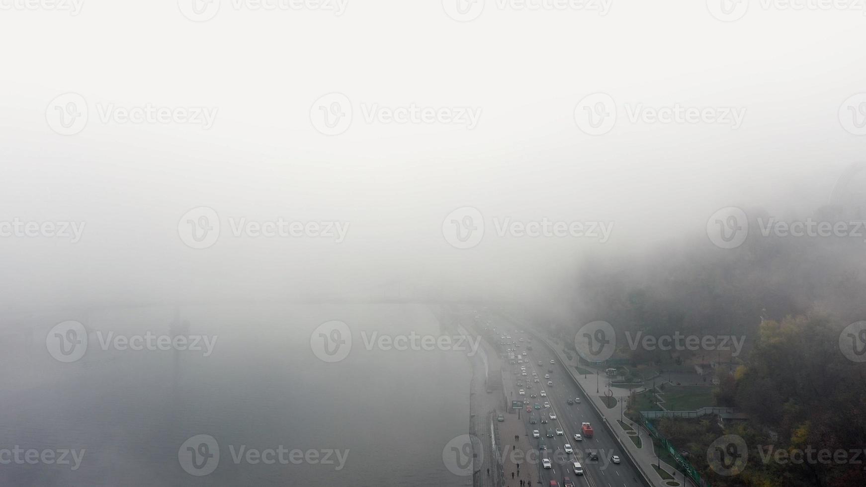 A city covered in fog. City traffic, aerial view photo