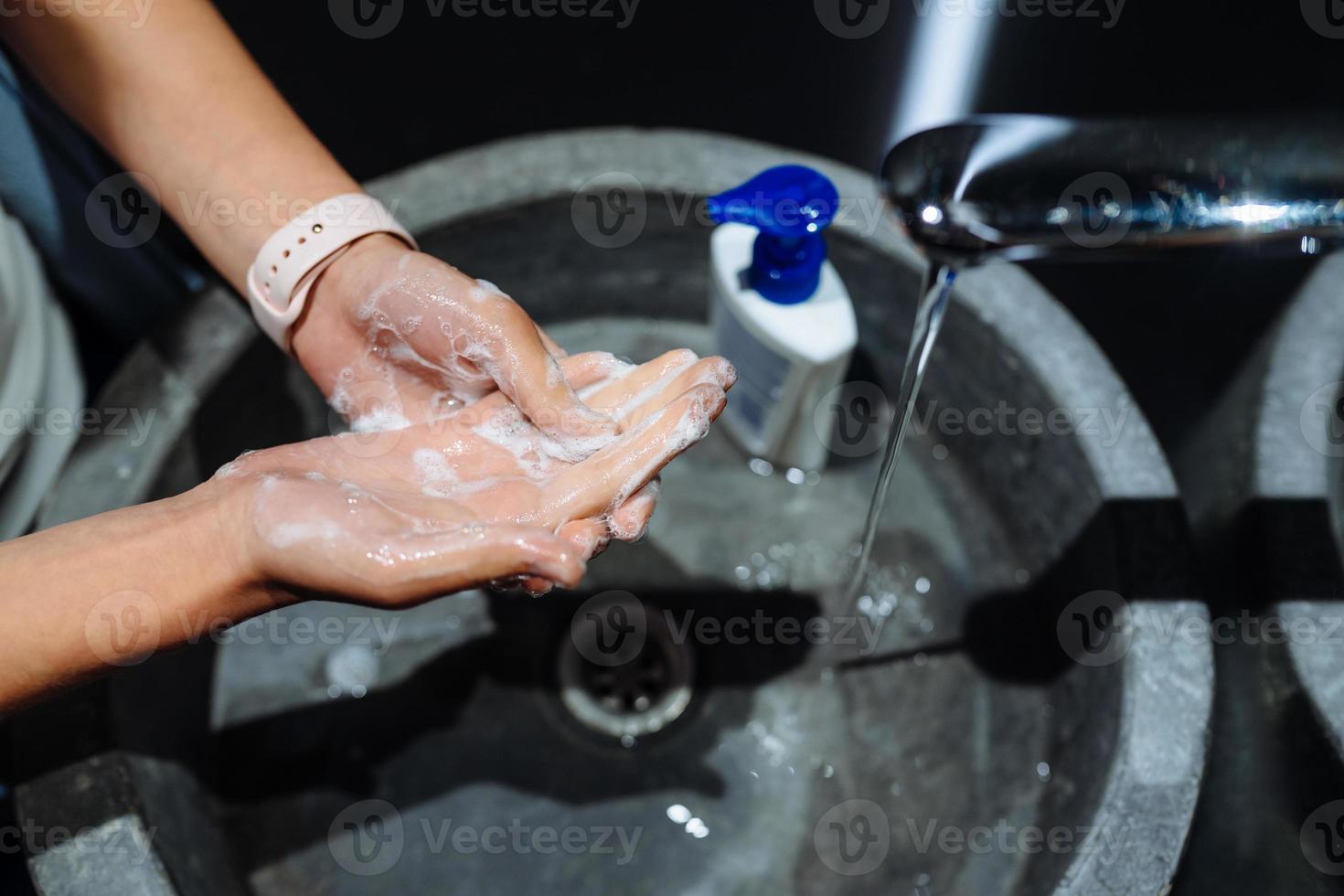 Man washing hands to protect against the coronavirus photo