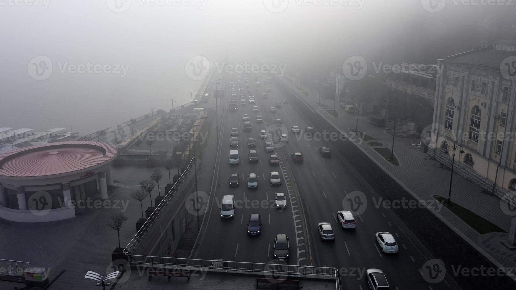 A city covered in fog. City traffic, aerial view photo