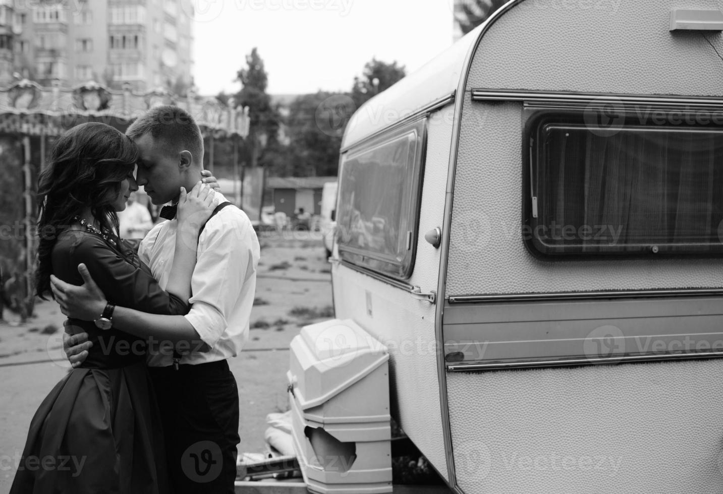 man and woman is hidden from view behind a trailer photo