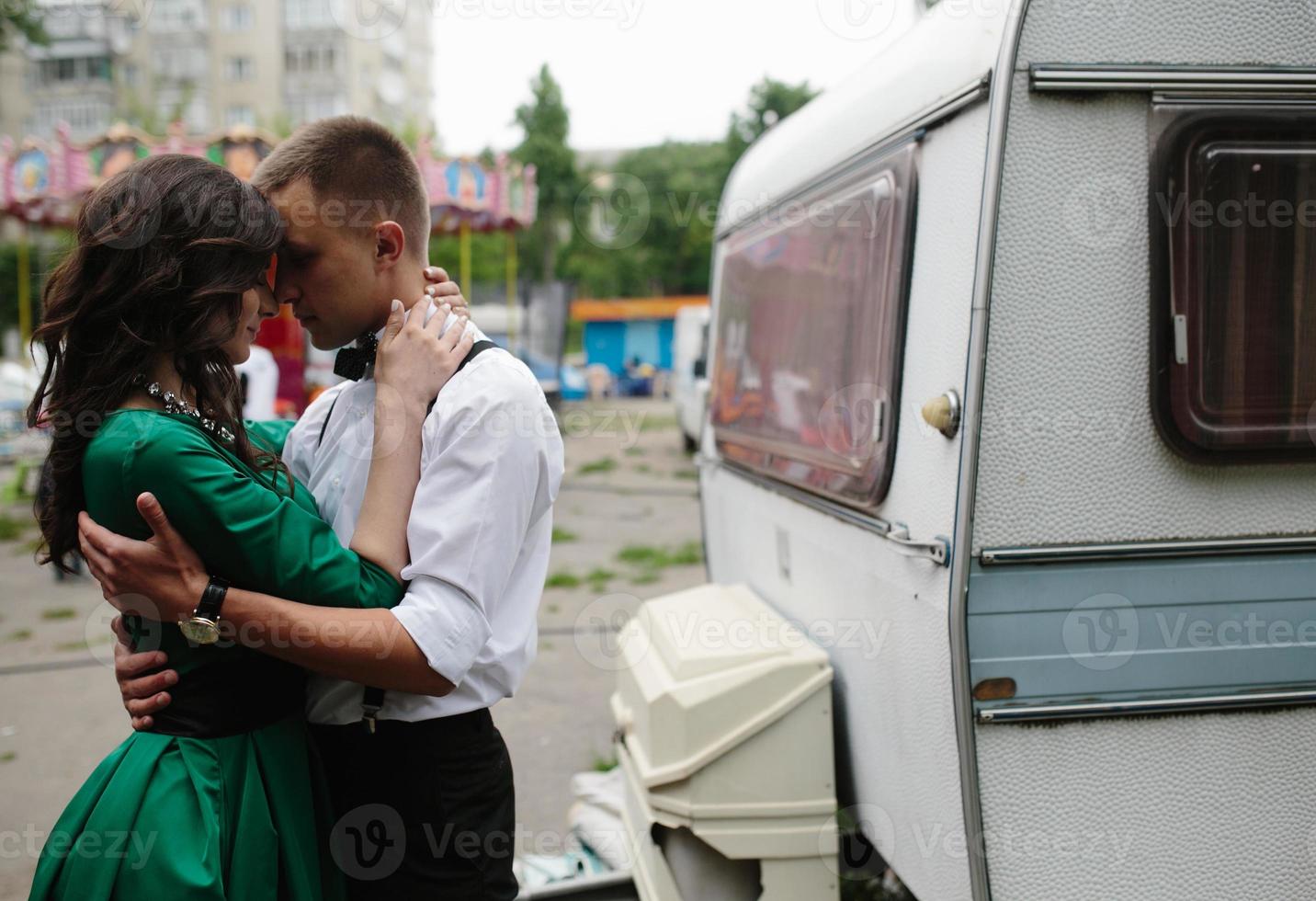 man and woman is hidden from view behind a trailer photo