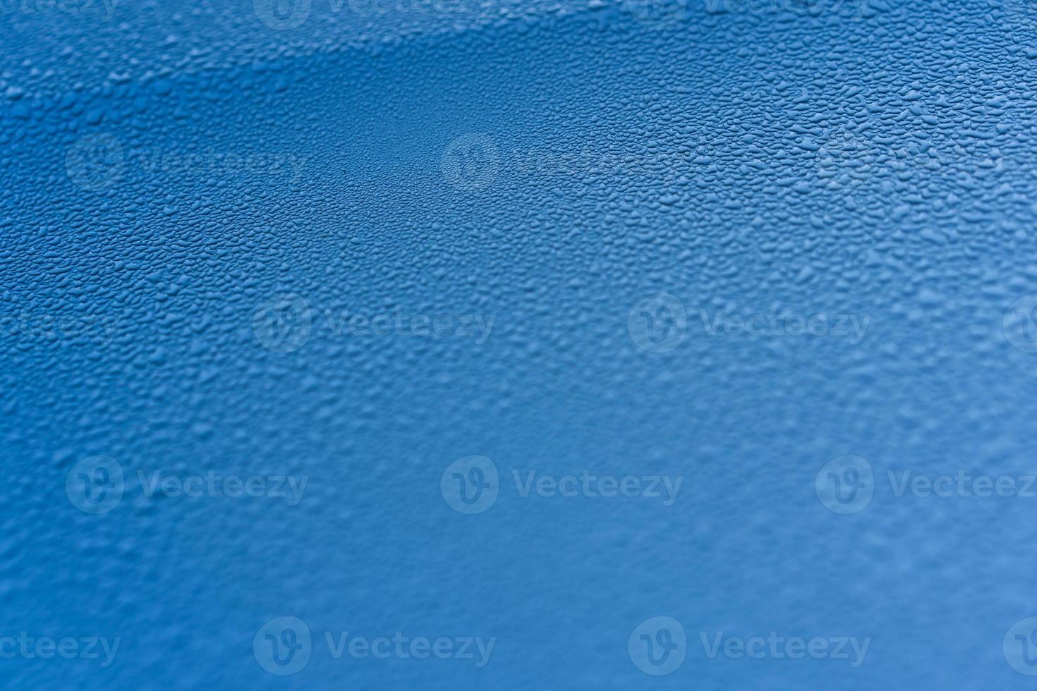 Raindrops on the hood of the car. Close-up. photo