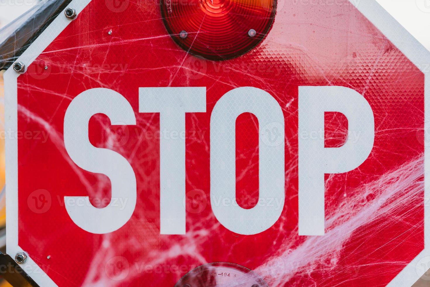 School bus with stop sign decorated with cobwebs photo